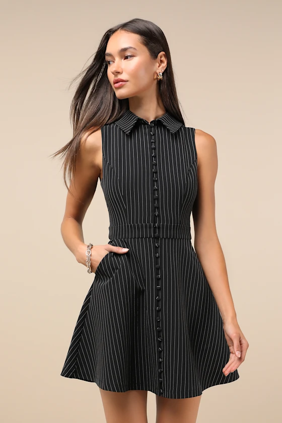 A woman in a dark olive corduroy button-front short sleeve mini dress.
